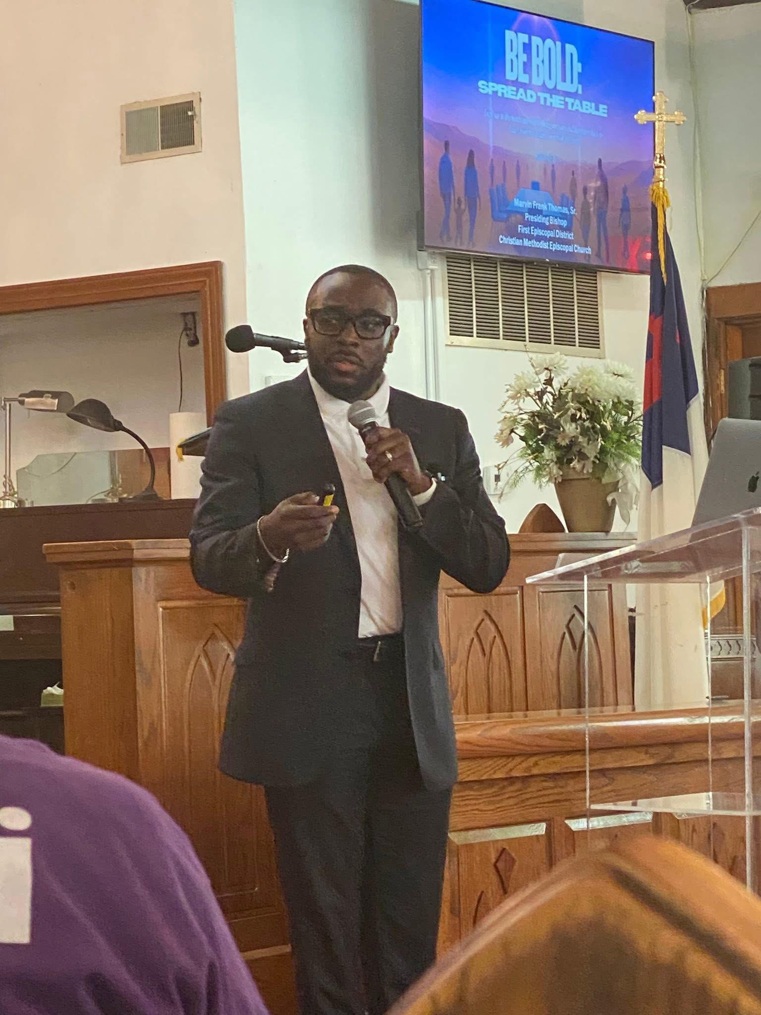 Dr. Jonathan Lotson presenting with a microphone
